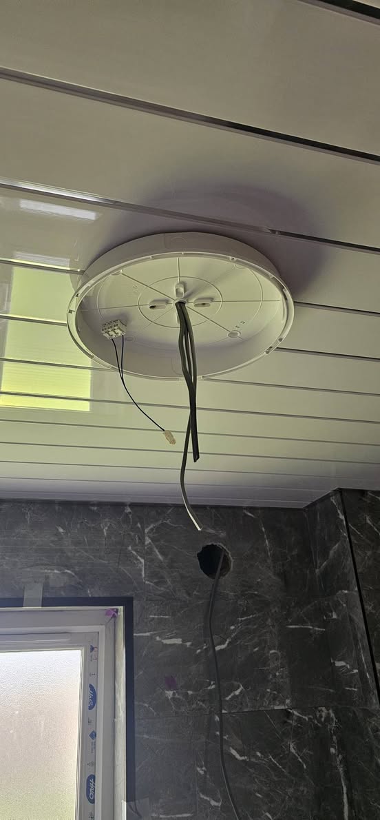 Bathroom light wiring installation in progress by RCD Electrical Sheffield — Ansell Lighting fitting being connected